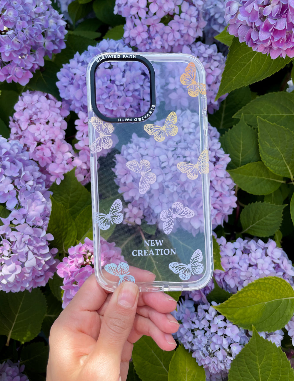 Clear phone case with pastel butterflies and New Creation text, raised edges