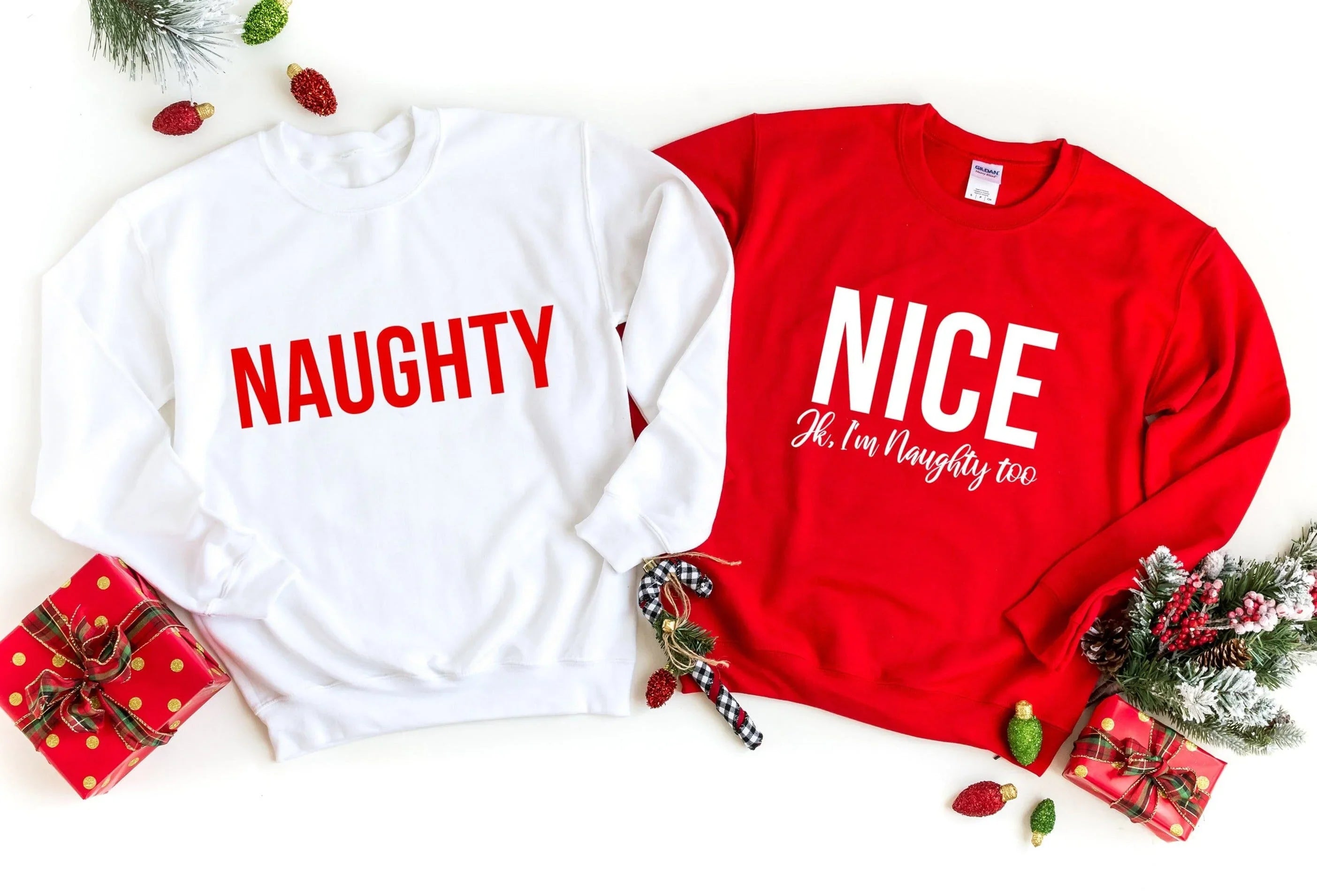 Two graphic sweatshirts: white 'NAUGHTY' and red 'NICE' with 'JK, I'm Naughty too'