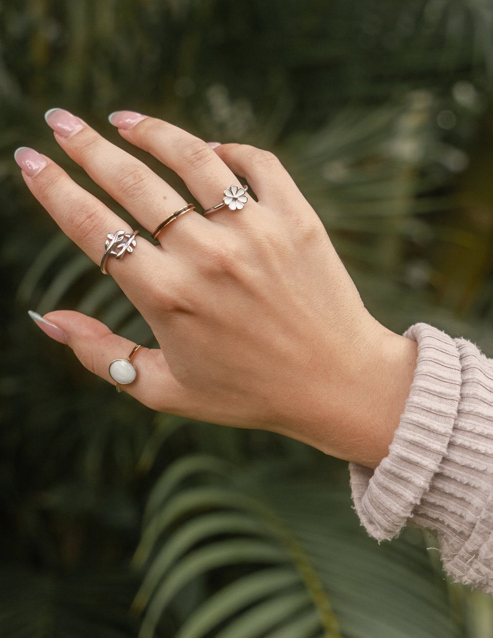 Silver olive branch ring on finger with leaf motif