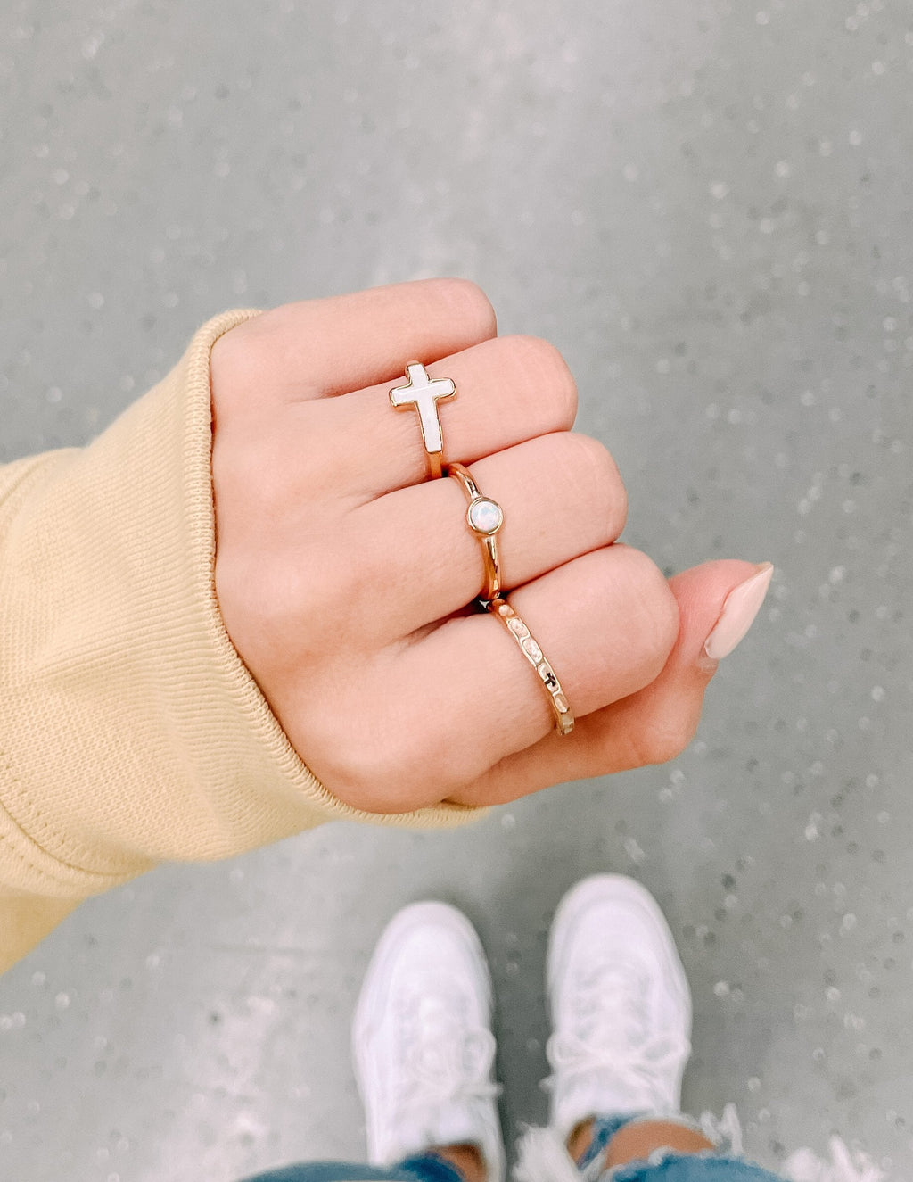 Rose gold pearl ring with round opal-like stone on finger