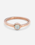 Rose gold pearl ring with round opal-like stone bezel