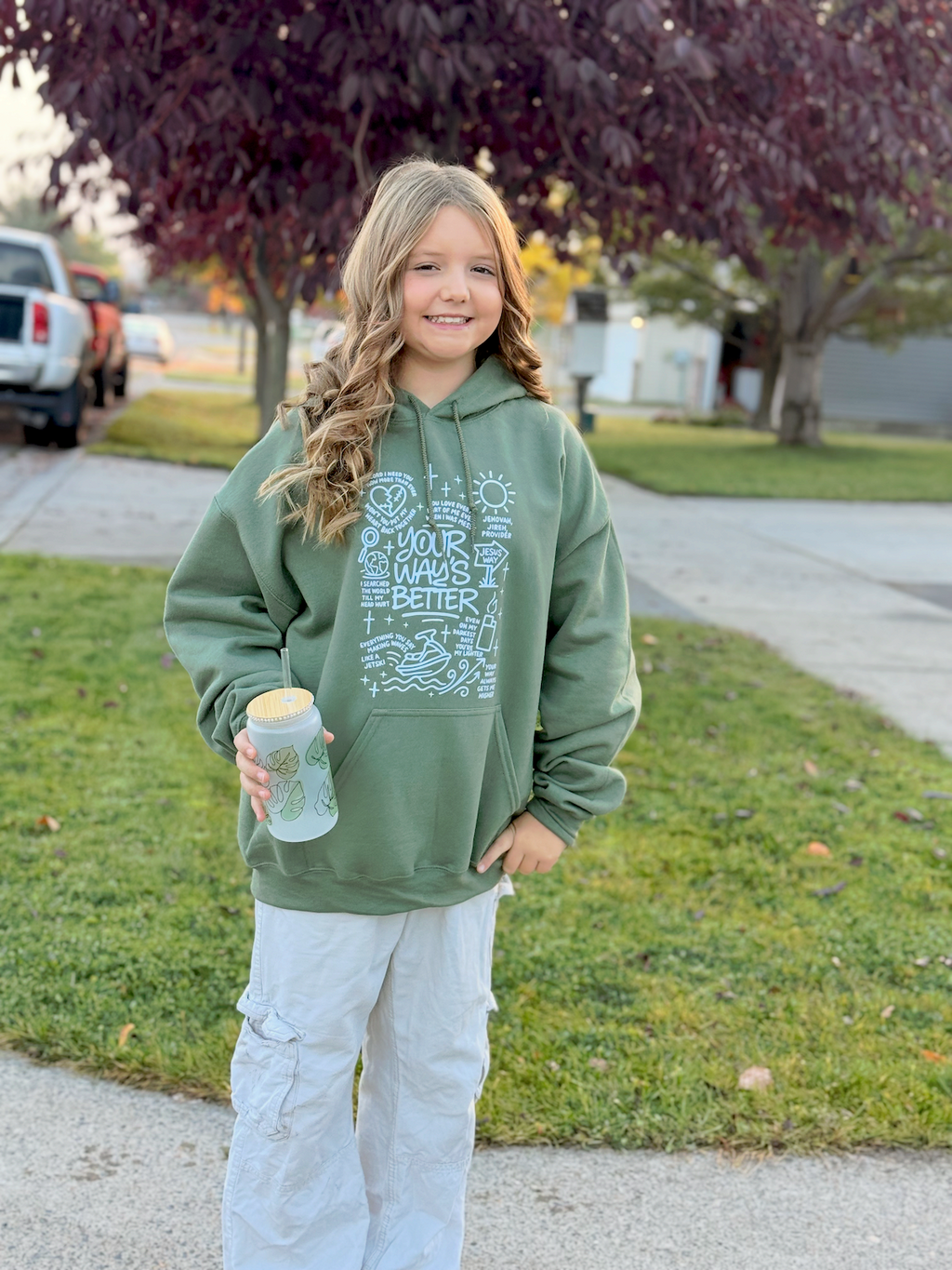 Military green hoodie with white scripture-style graphic on front pocket