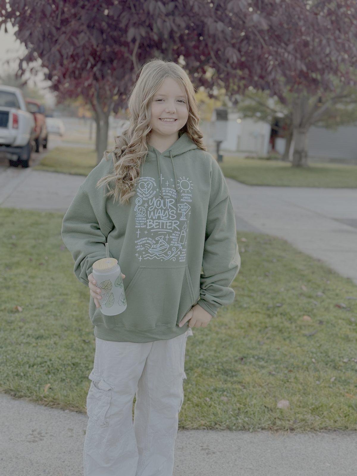 Military green hoodie with white scripture-style graphic on front pocket