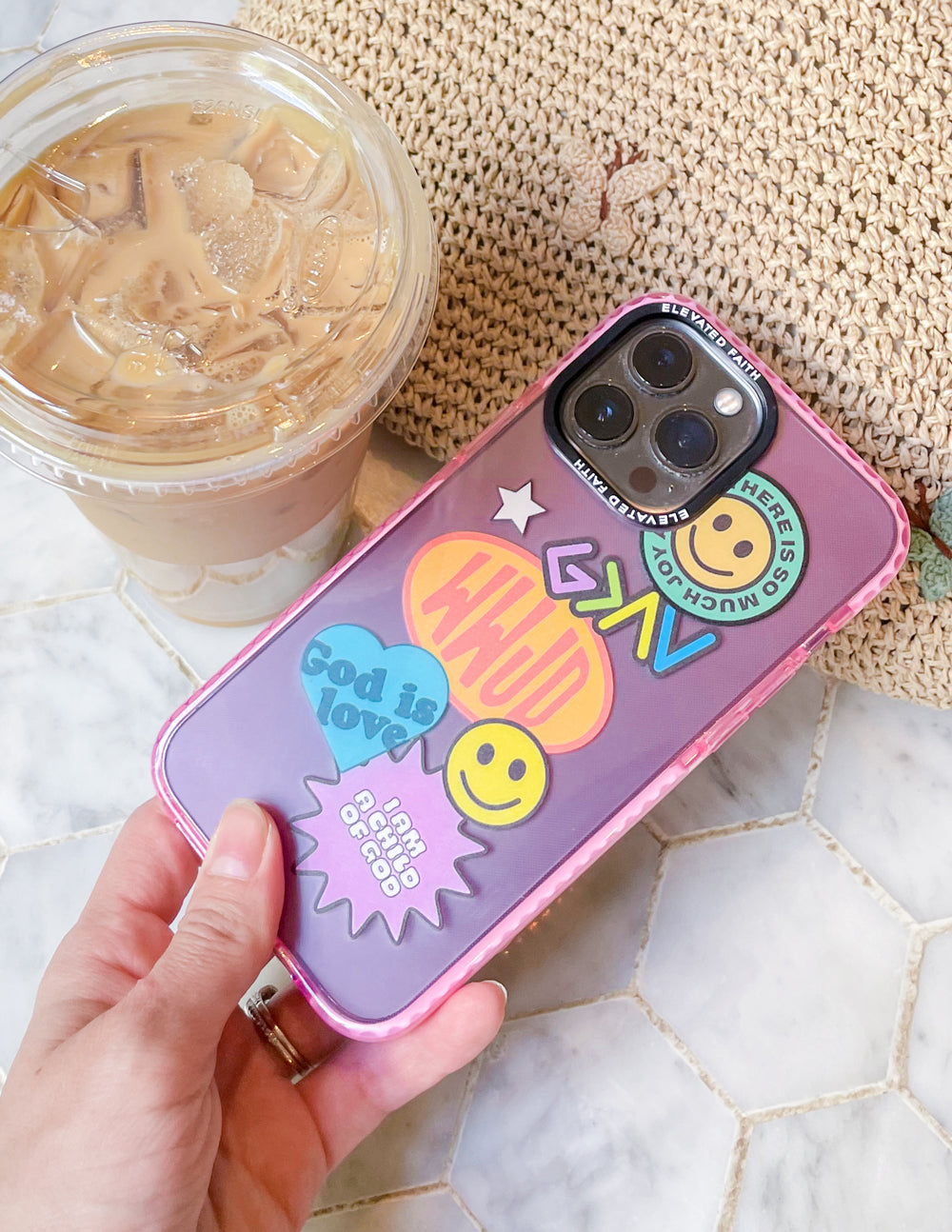 Pink phone case with purple sticker collage and smiley icons, clear camera cutout