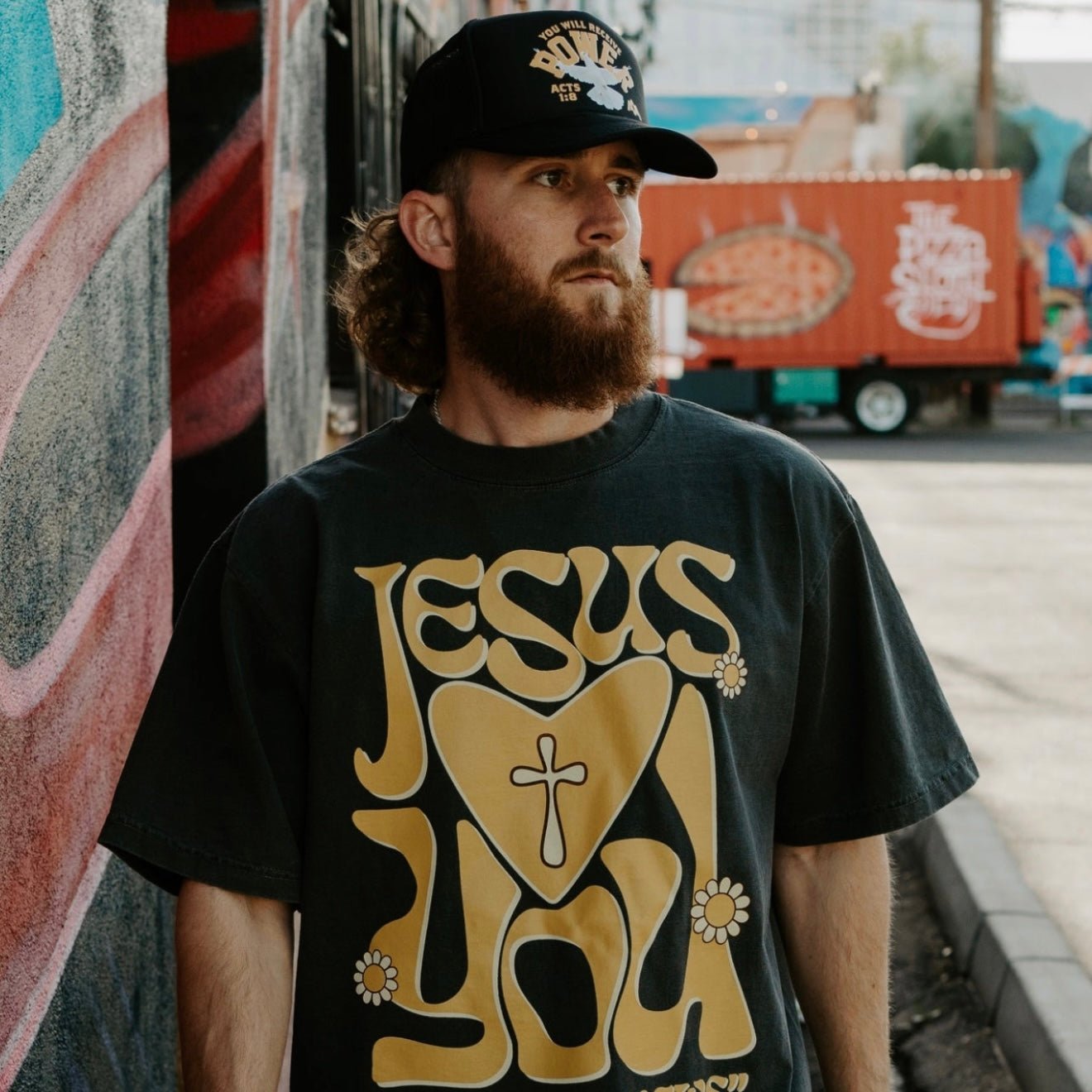 Black trucker cap with POWER logo and dove graphic, worn with brim forward