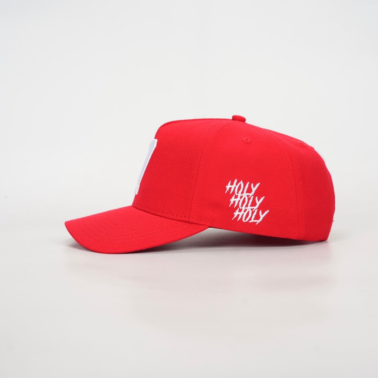 Red snapback cap with white script logo on side panel