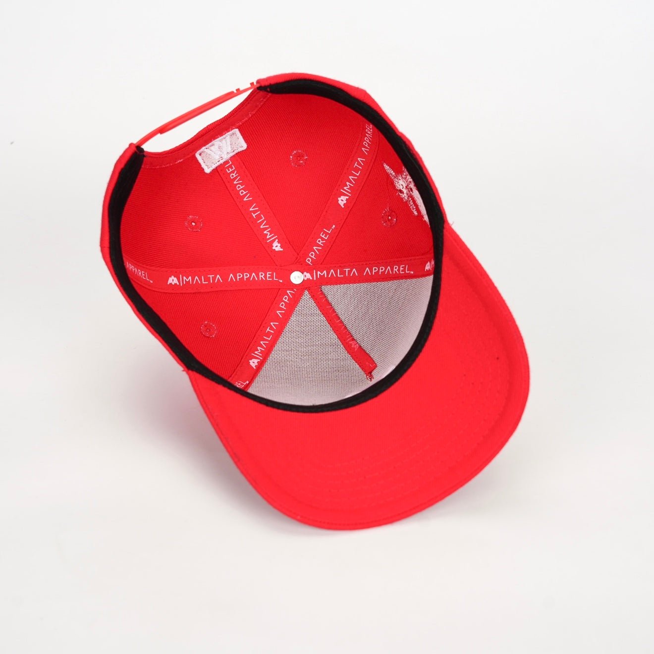 Red snapback cap interior with black brim and gray lining panel