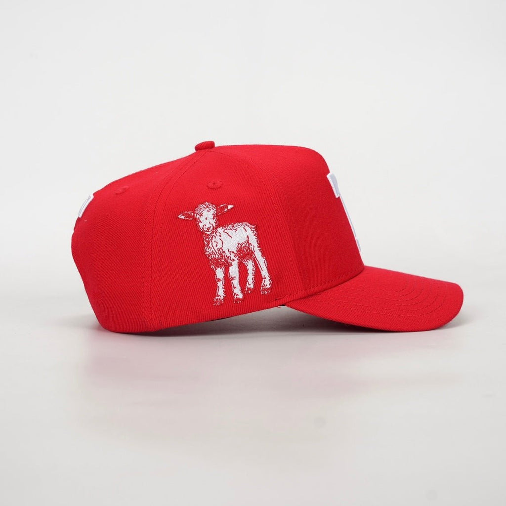 Red snapback cap with white animal graphic on side panel
