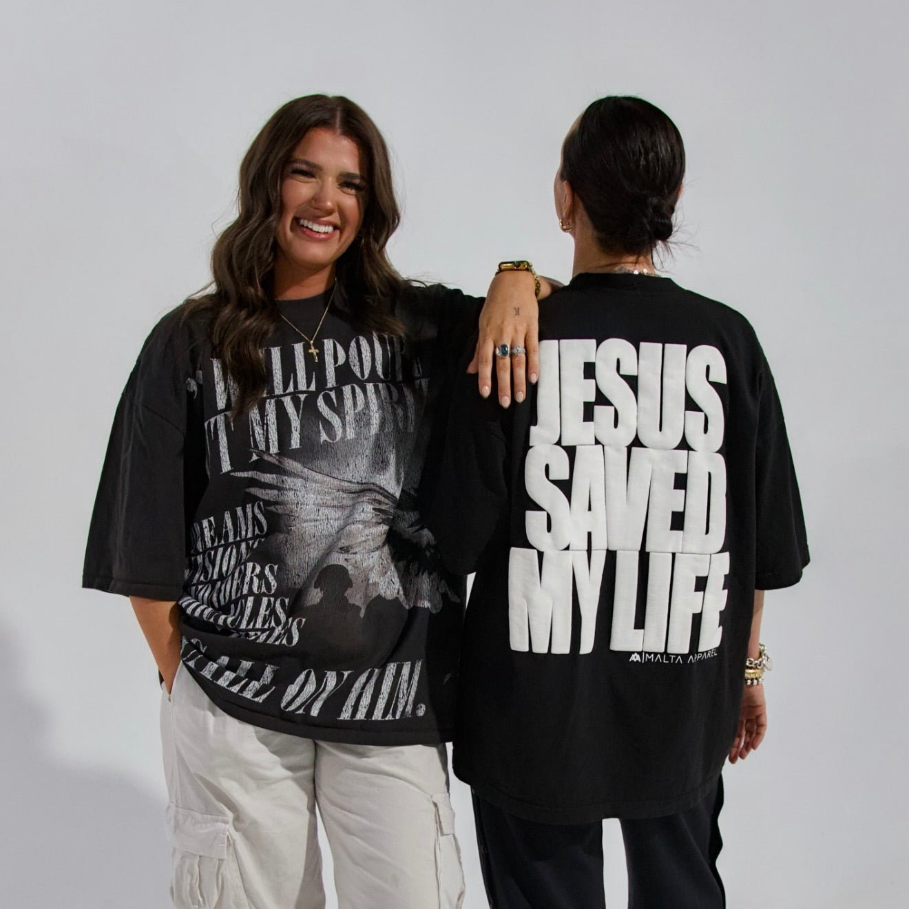 Black T-shirt back with large white puff print text: JESUS SAVED MY LIFE.