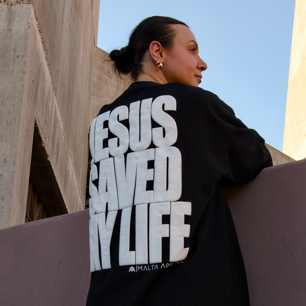 Black pullover hoodie with white puff-print back graphic in stacked letters