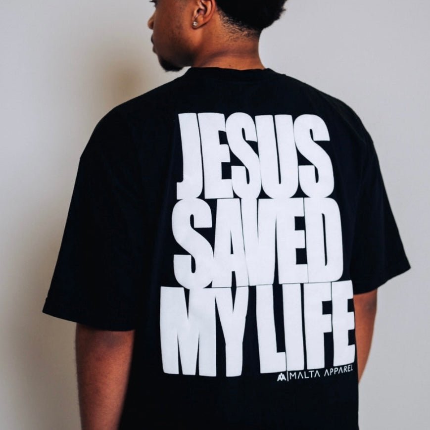 Black T-shirt back with large white puff print text: JESUS SAVED MY LIFE.