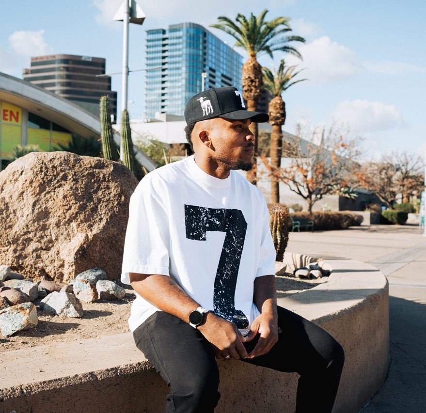Black snapback cap with white "7" logo