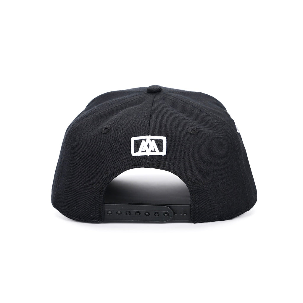Black snapback cap with adjustable strap and small white logo patch on back