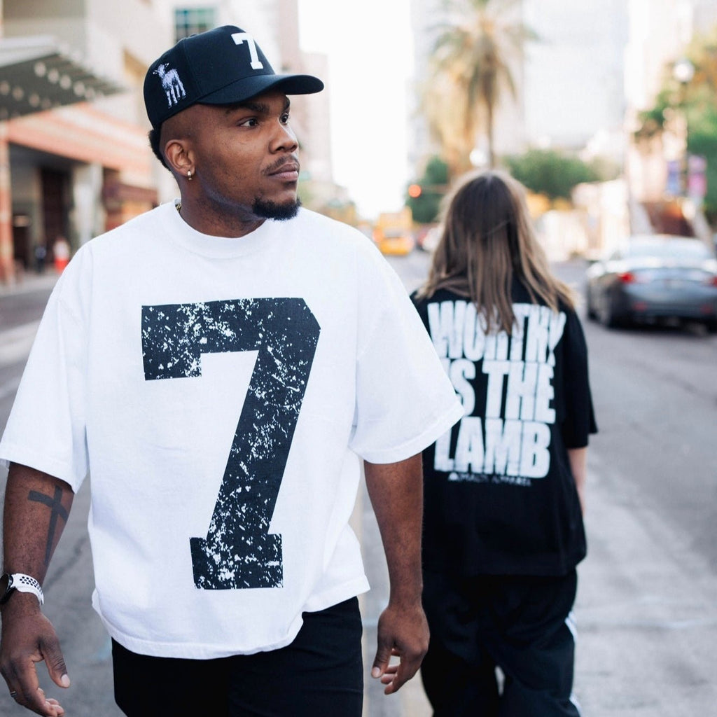 Black snapback cap with white "holy" text graphic on side