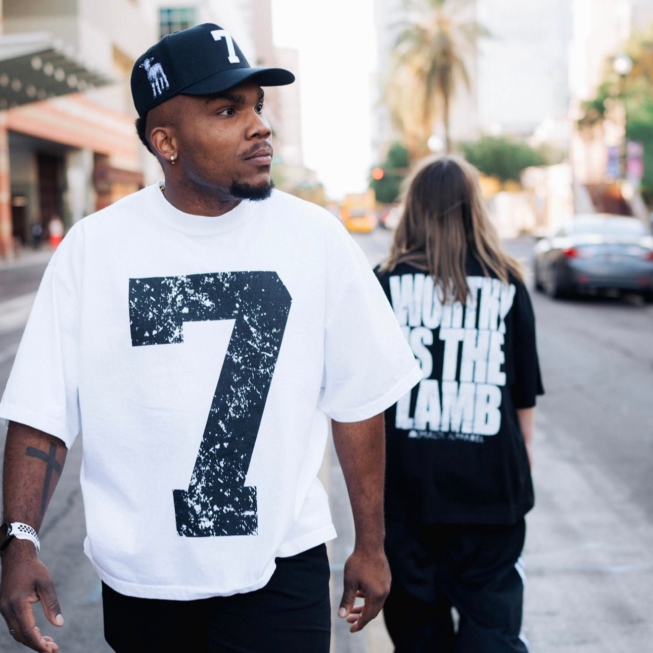 Black snapback cap with white "holy" text graphic on side