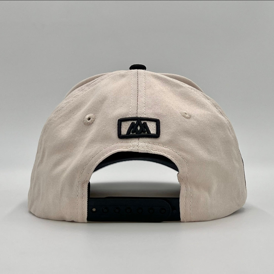 Snapback cap back view with black label patch and vented crown.