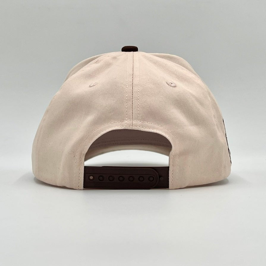 Cream snapback cap back with brown adjustable strap panel