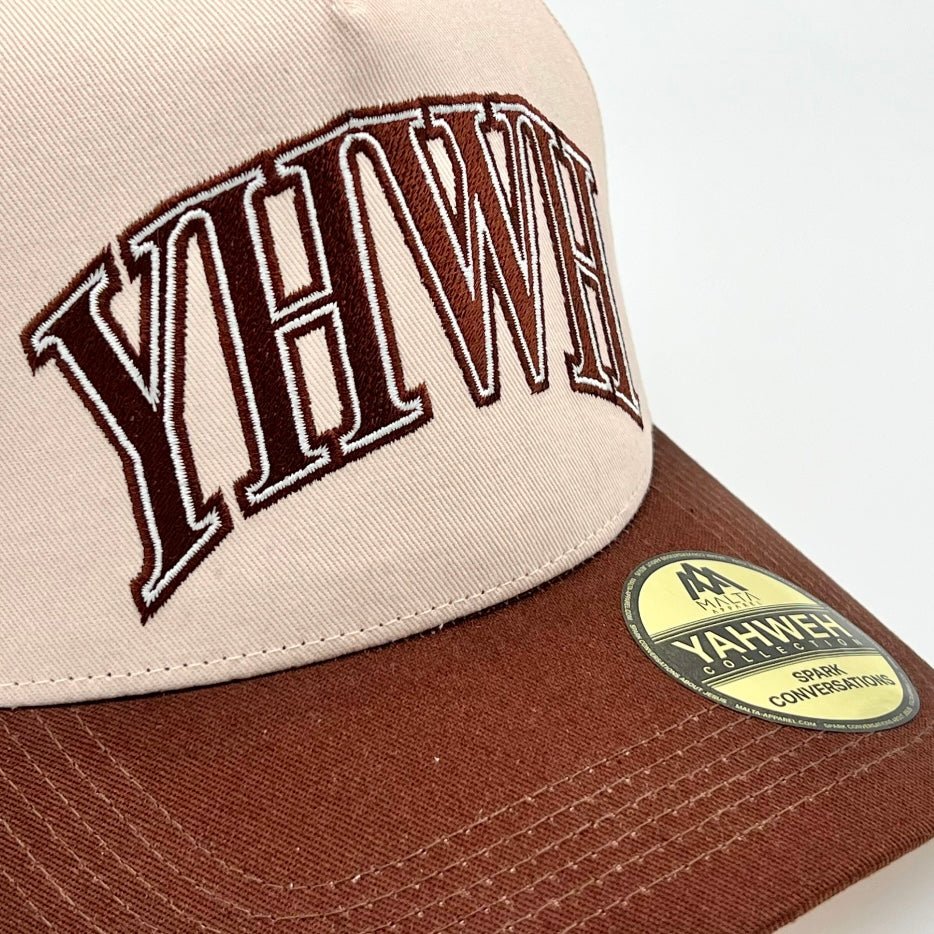 Cream and brown snapback cap close-up with YHWH logo and YAHWEH patch