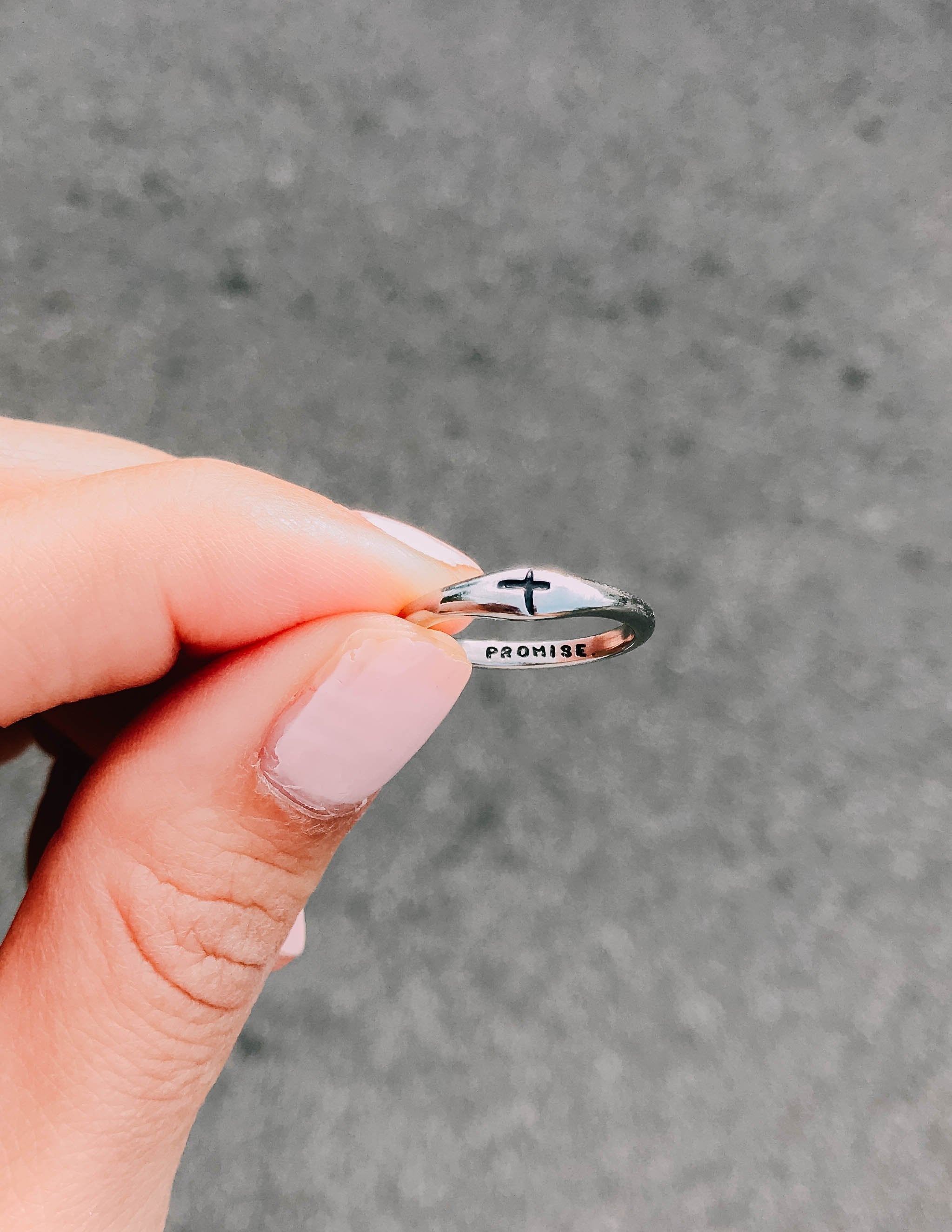 Silver promise ring top view with black cross and 'PROMISE' engraving
