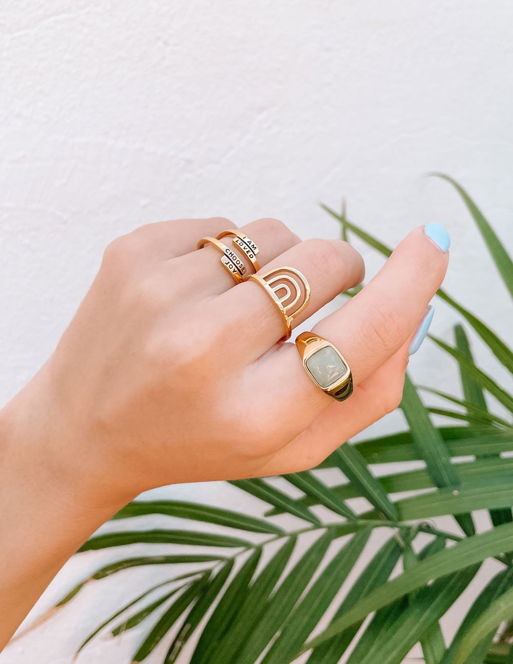 Rainbow arch ring on hand, gold-tone band with stacked arches