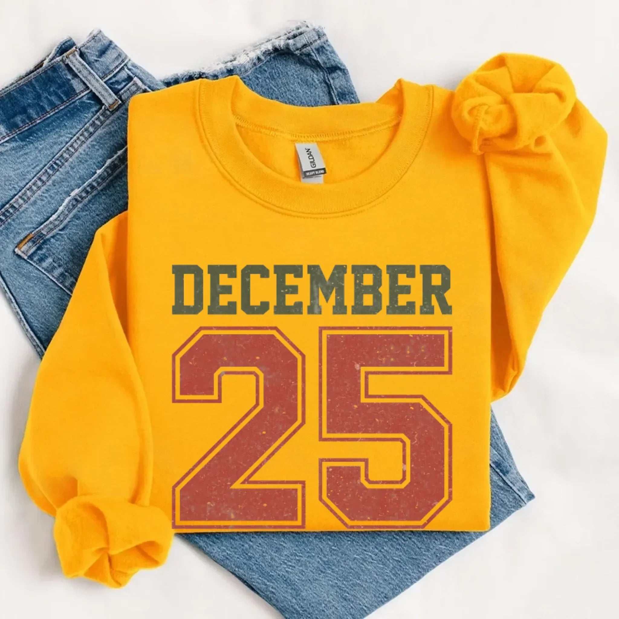 Mustard yellow crewneck sweatshirt with 'DECEMBER 25' front graphic
