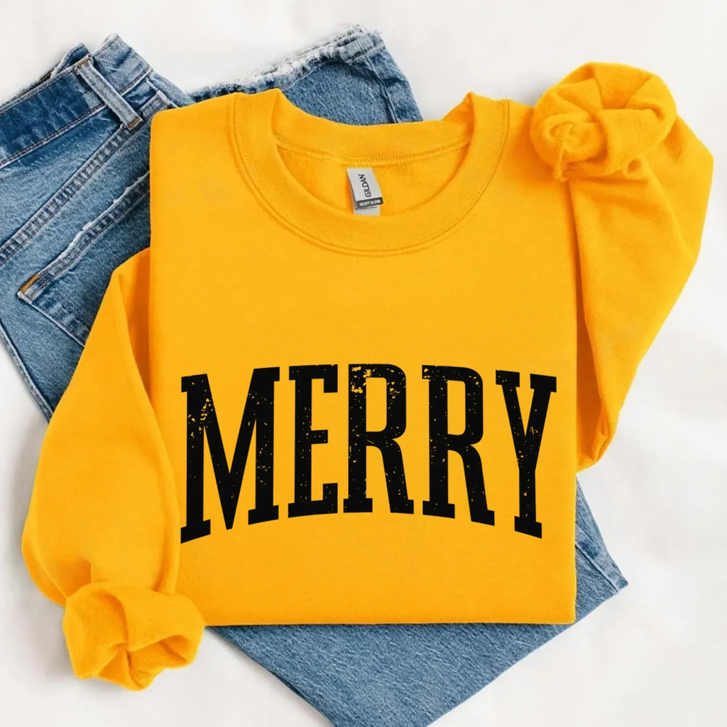 Women’s holiday sweatshirt in mustard yellow with “MERRY” front graphic and crewneck