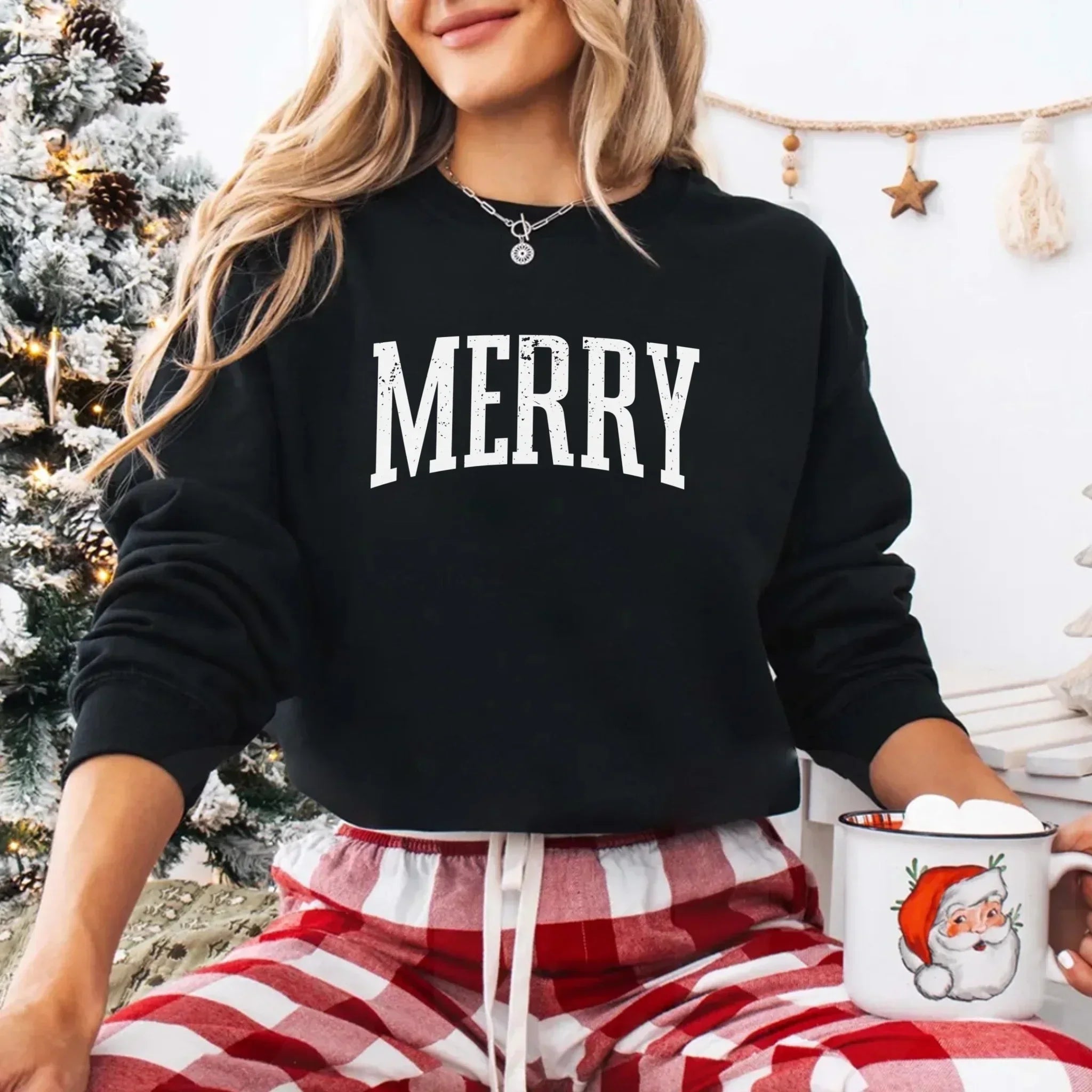 Black crewneck sweatshirt with "MERRY" white chest print