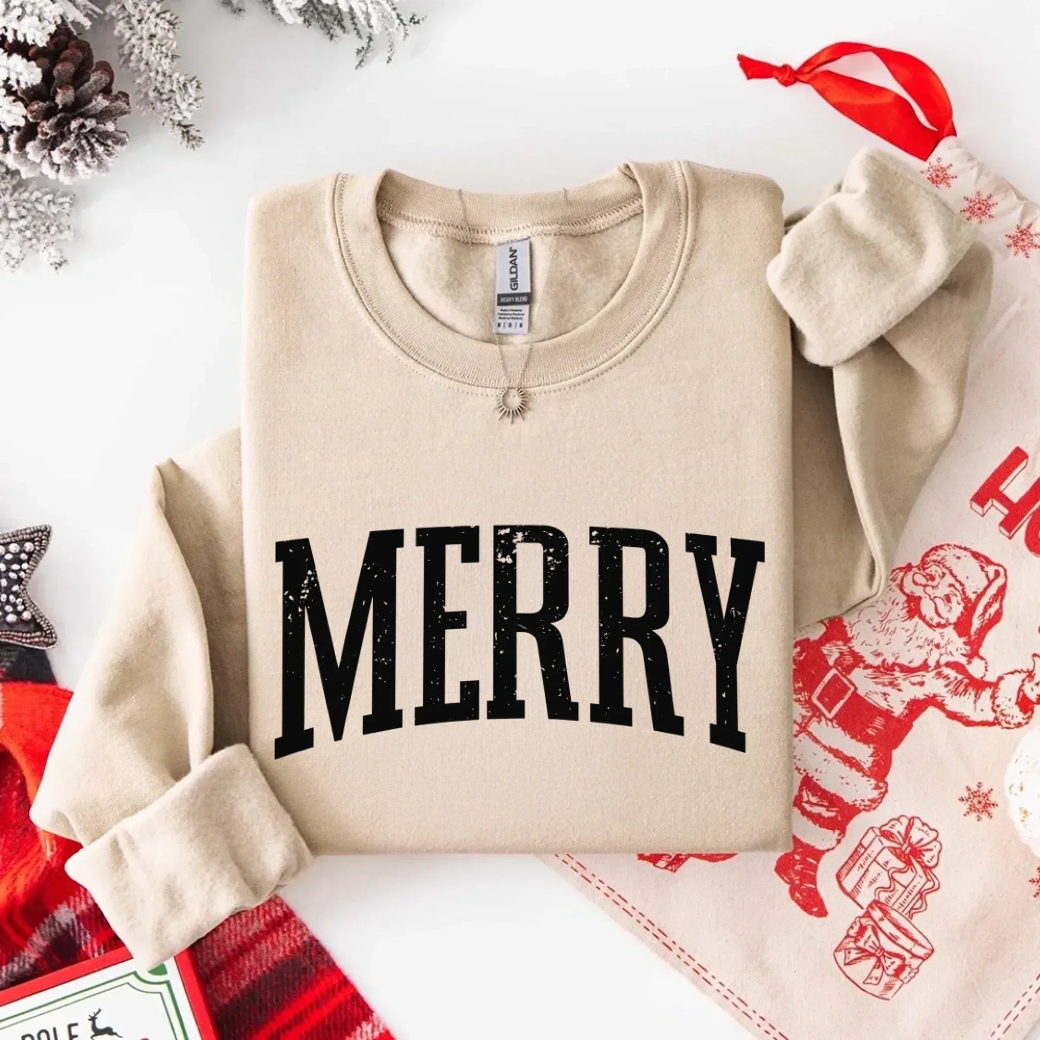 Sand crewneck sweatshirt with bold black "MERRY" graphic