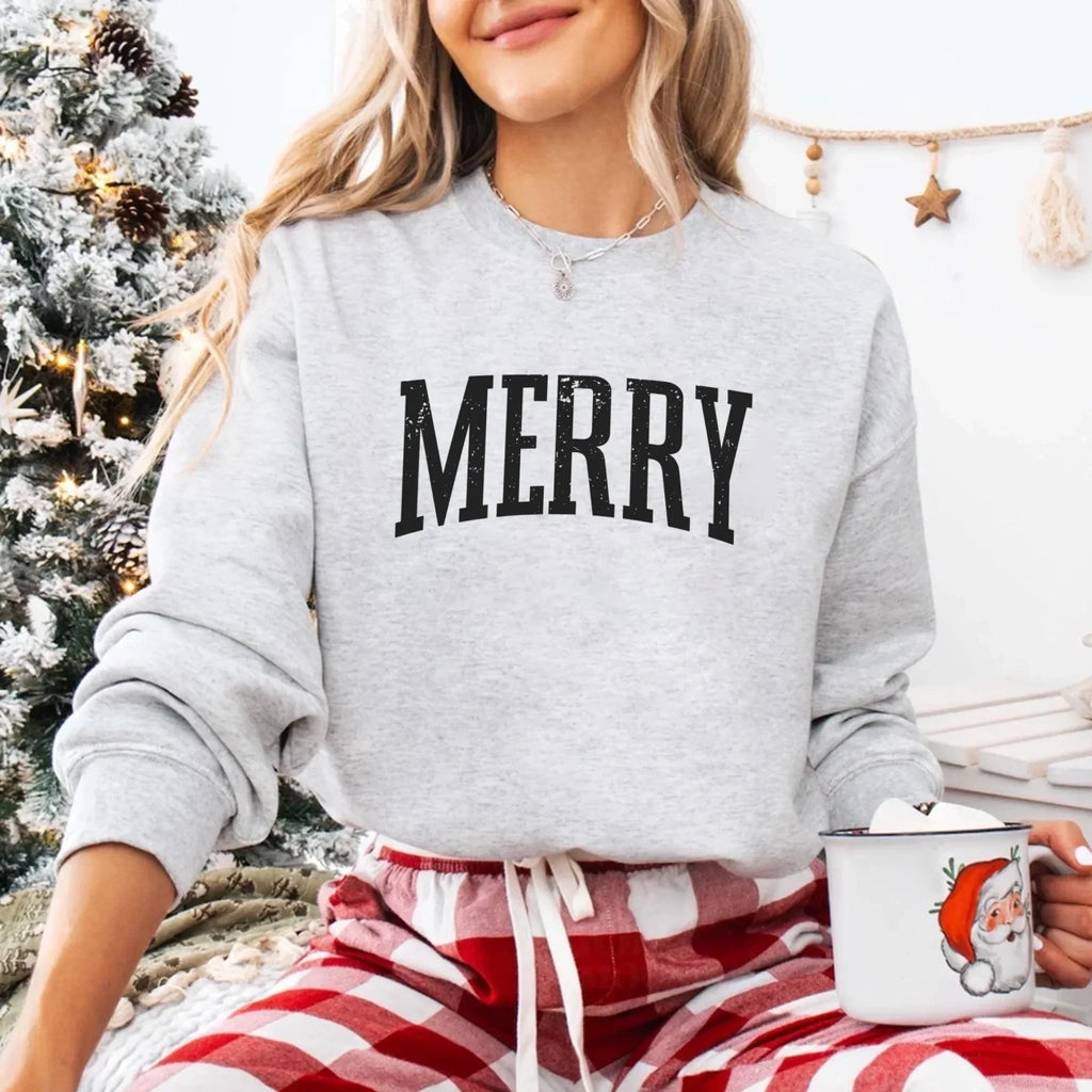 Women’s holiday sweatshirt in light gray with “MERRY” front graphic and crewneck
