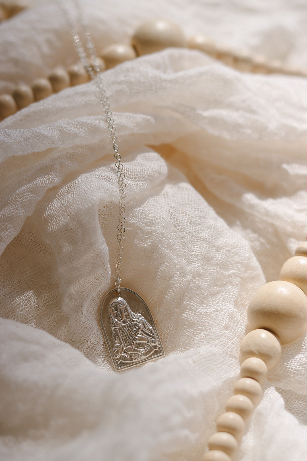 Sterling silver necklace with oval saint portrait pendant on a fine chain