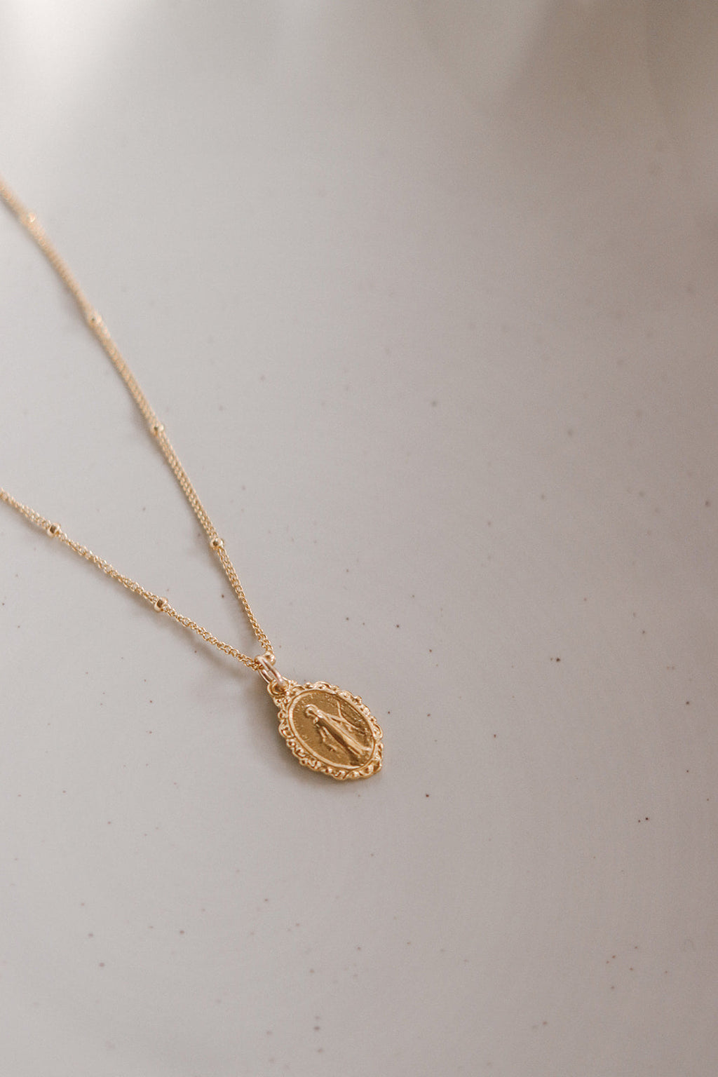 Gold-tone chain necklace with oval Miraculous medal pendant