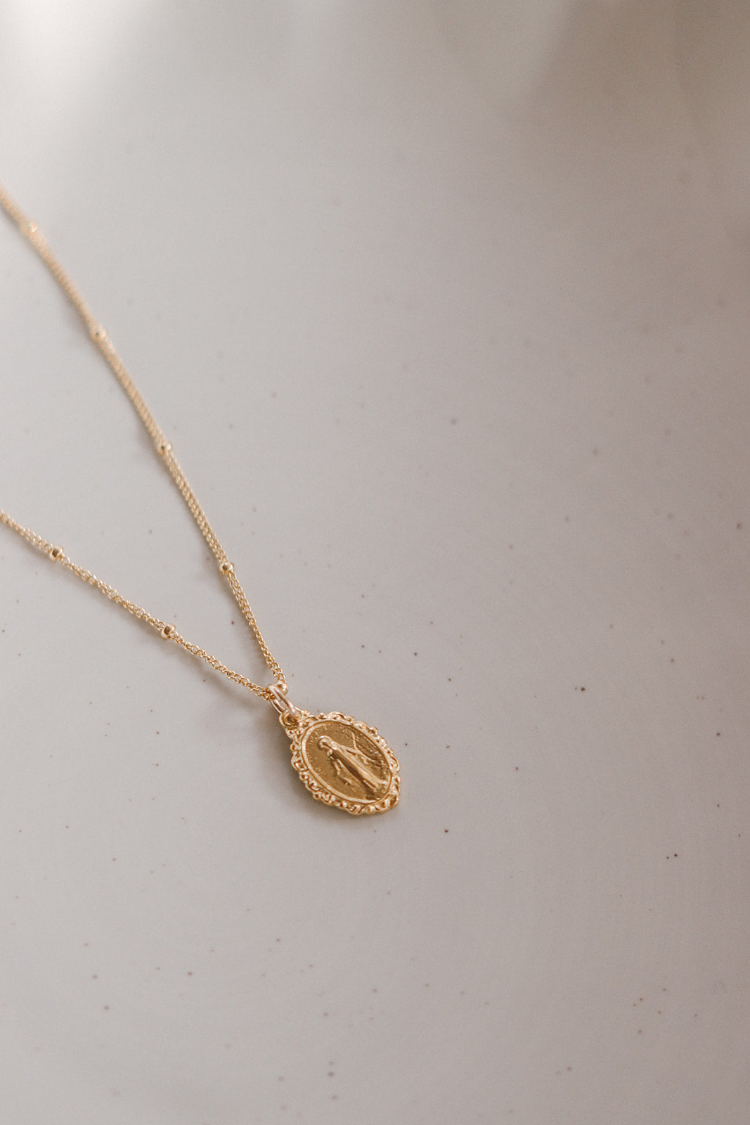 Gold-tone chain necklace with oval Miraculous medal pendant
