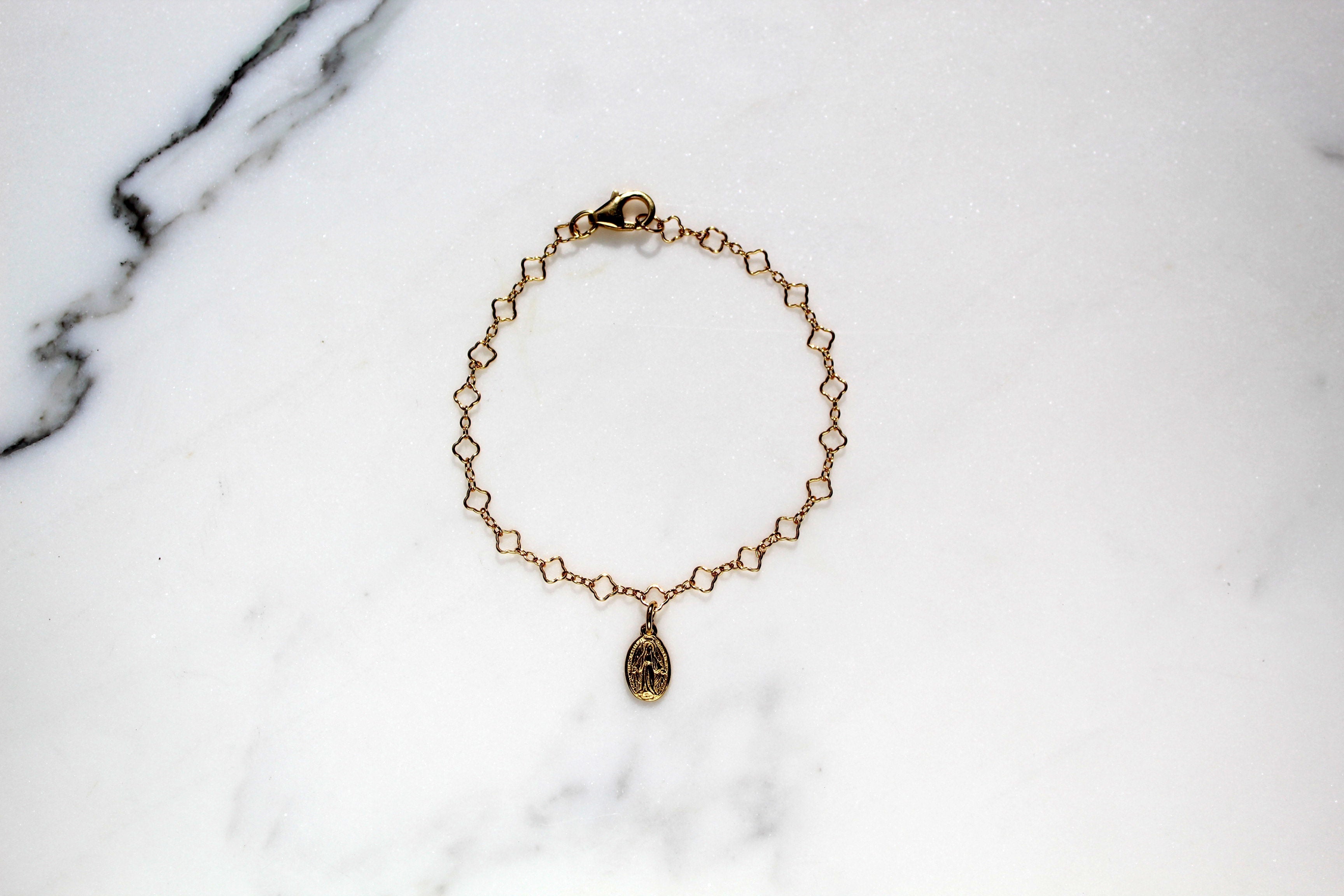 Gold chain charm bracelet with circular medallion charm