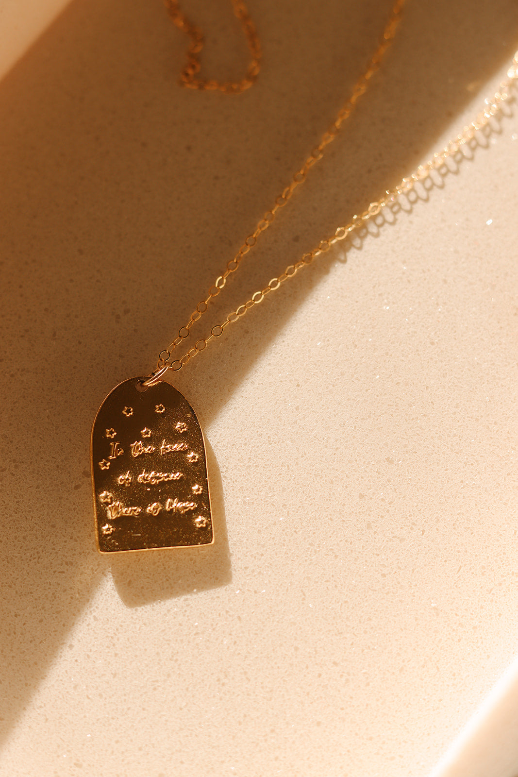 Gold St. Catherine of Sweden pendant necklace with heart-shaped charm and engraved text