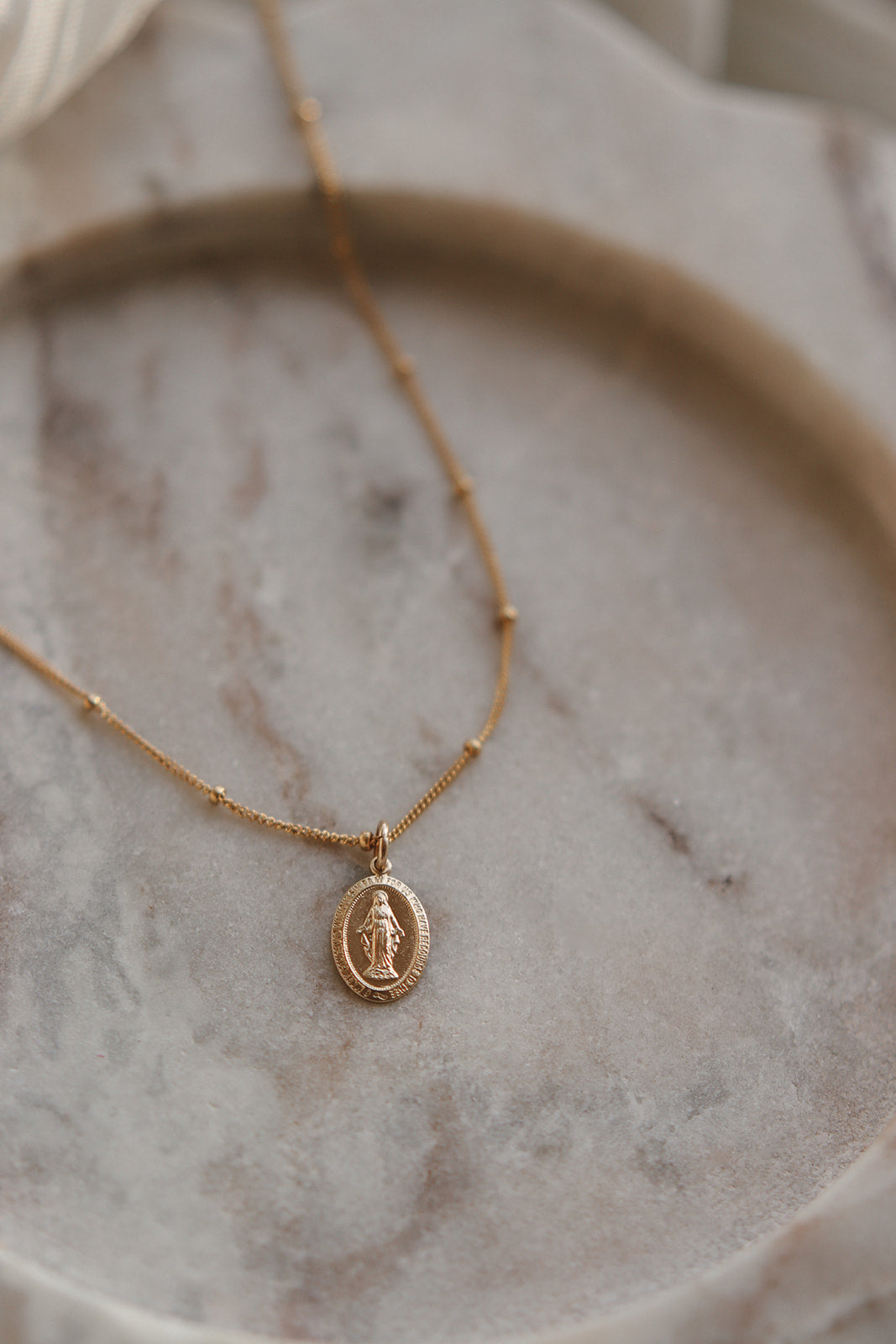 Gold-tone chain necklace with oval Miraculous Medal pendant, Mary figure centered