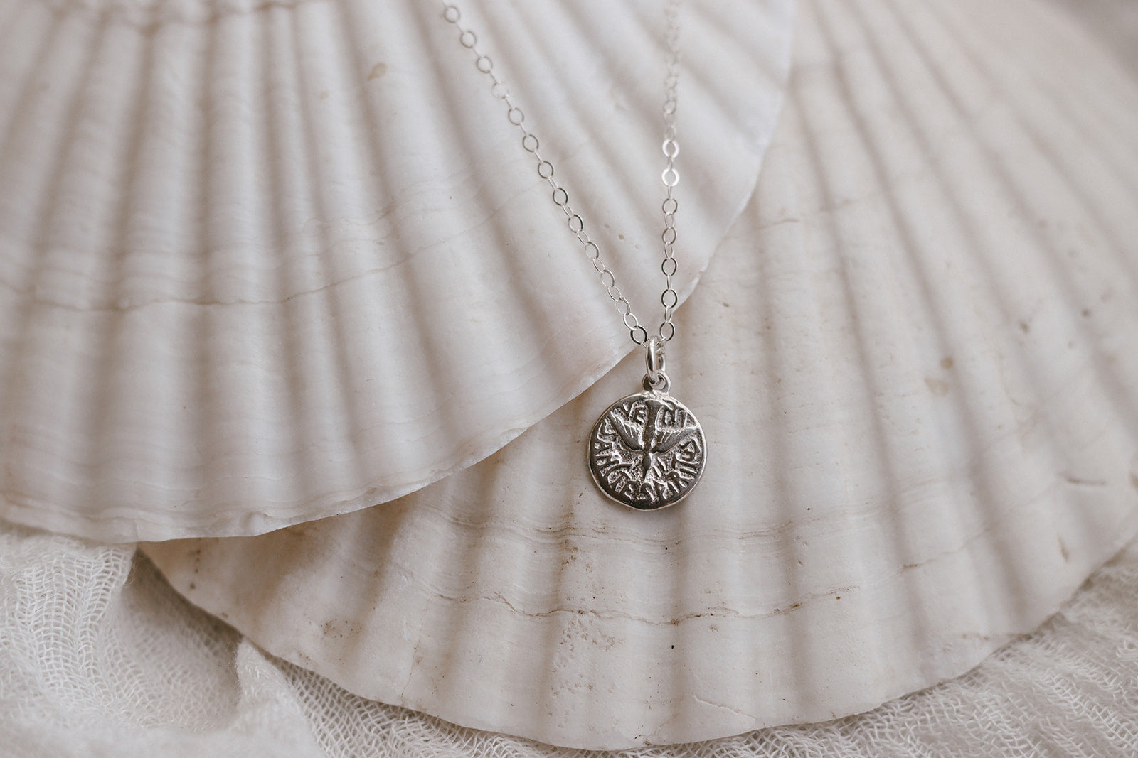 Sterling silver necklace with circular Holy Spirit pendant on fine chain