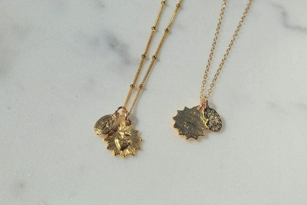 Gold-tone pendant necklace with sacred heart and Miraculous Medal charms