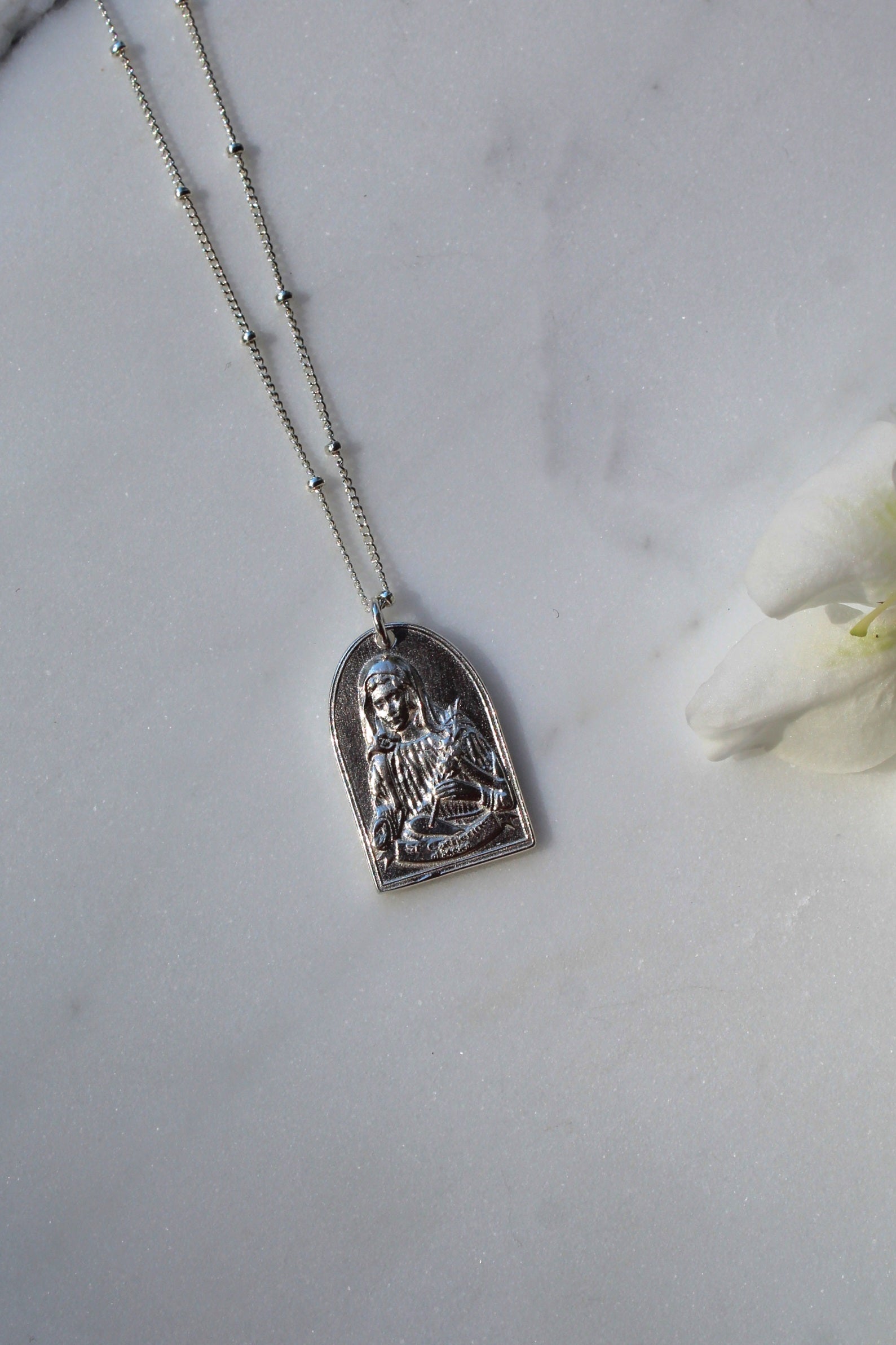 Sterling silver Saint Catherine pendant necklace with detailed arched saint charm on chain