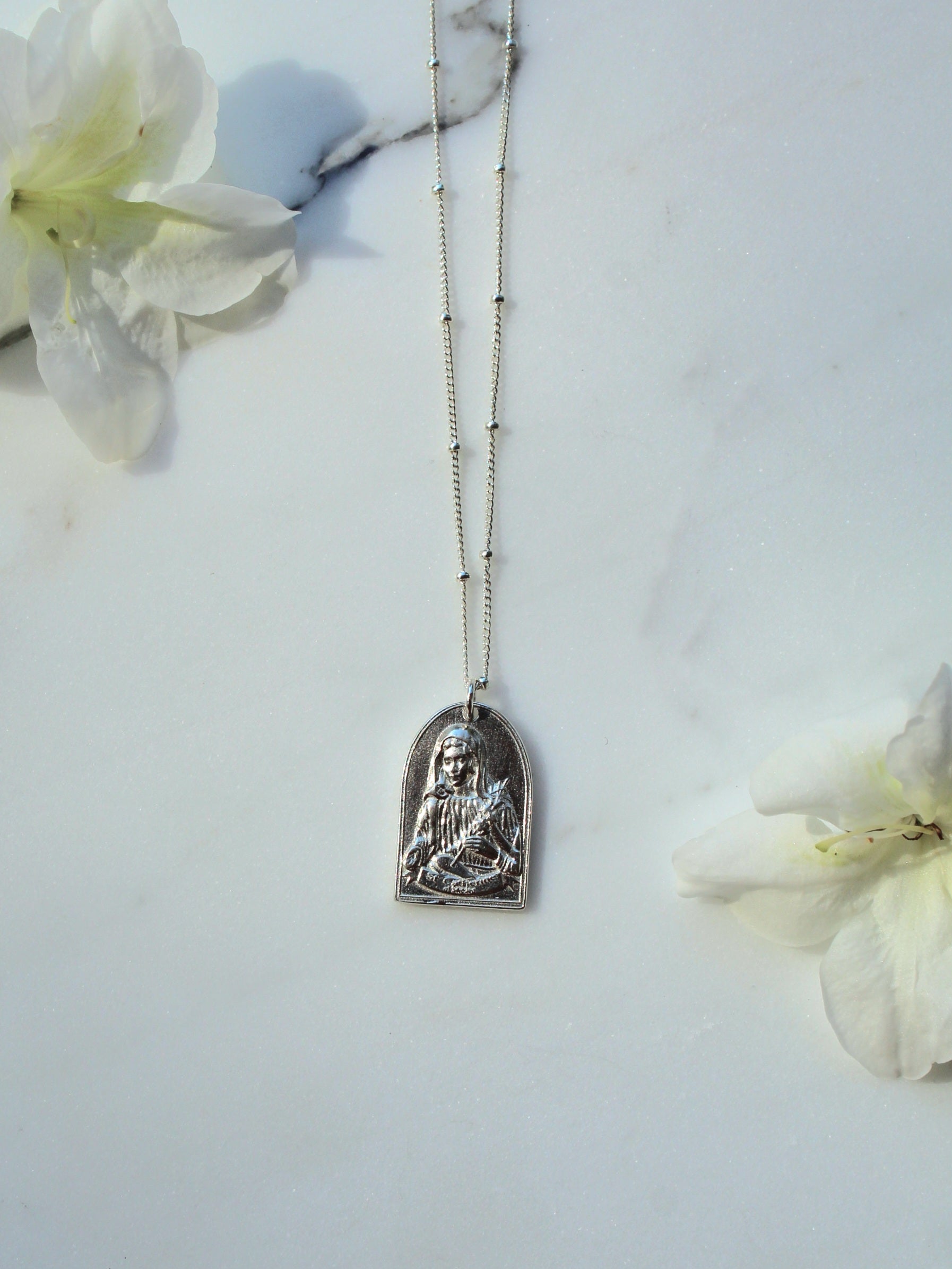 Sterling silver Saint pendant necklace with oval charm on thin chain