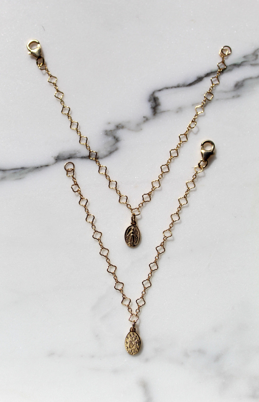 Gold chain bracelet with circular medallion charms and lobster clasp