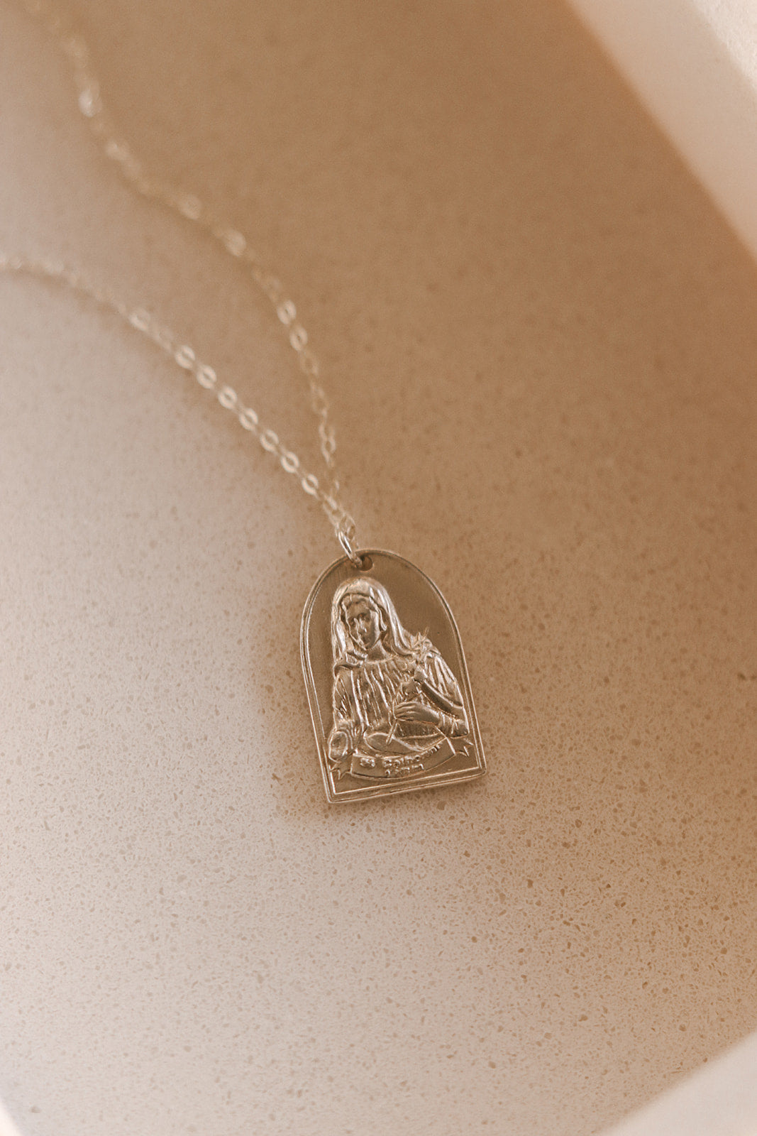 Sterling silver necklace with oval Saint figure pendant on a fine chain