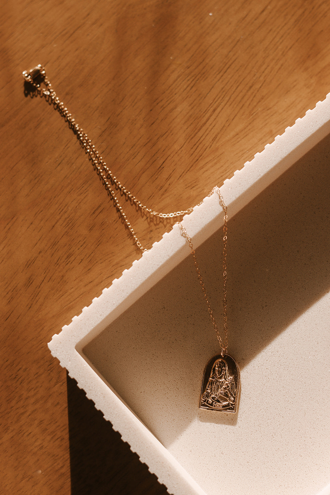 Gold St. Catherine of Sweden pendant necklace with heart-shaped charm and curb chain