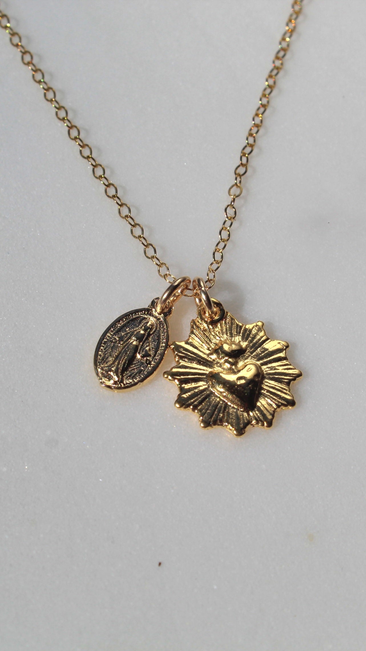 Gold-tone sacred heart and sunburst medal charm pendant on chain