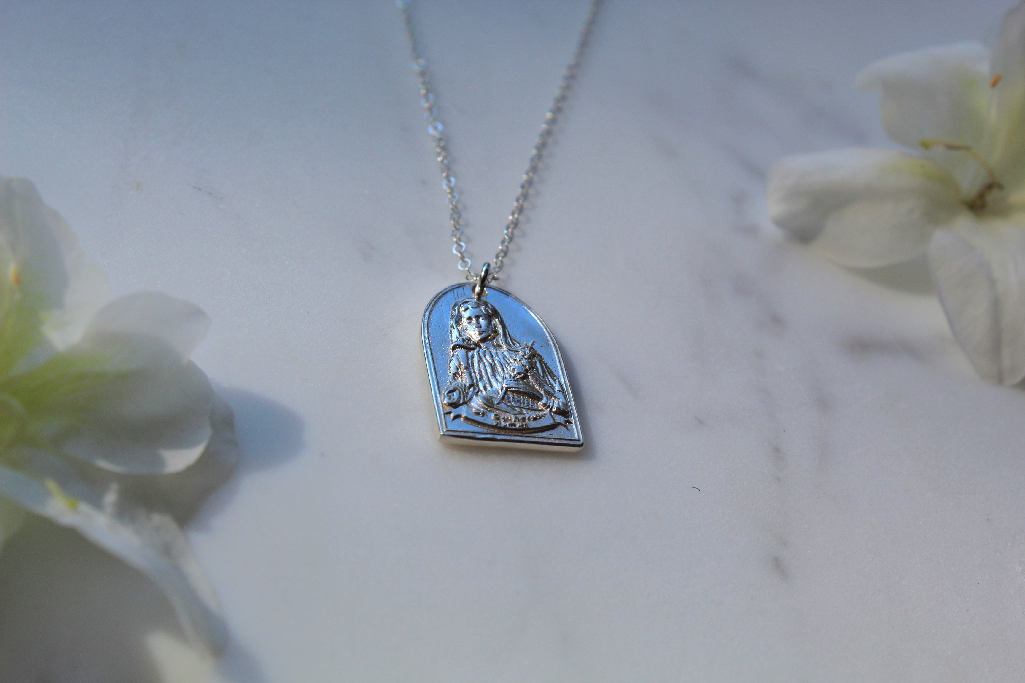Sterling silver necklace with blue enamel heart pendant, saint relief on chain