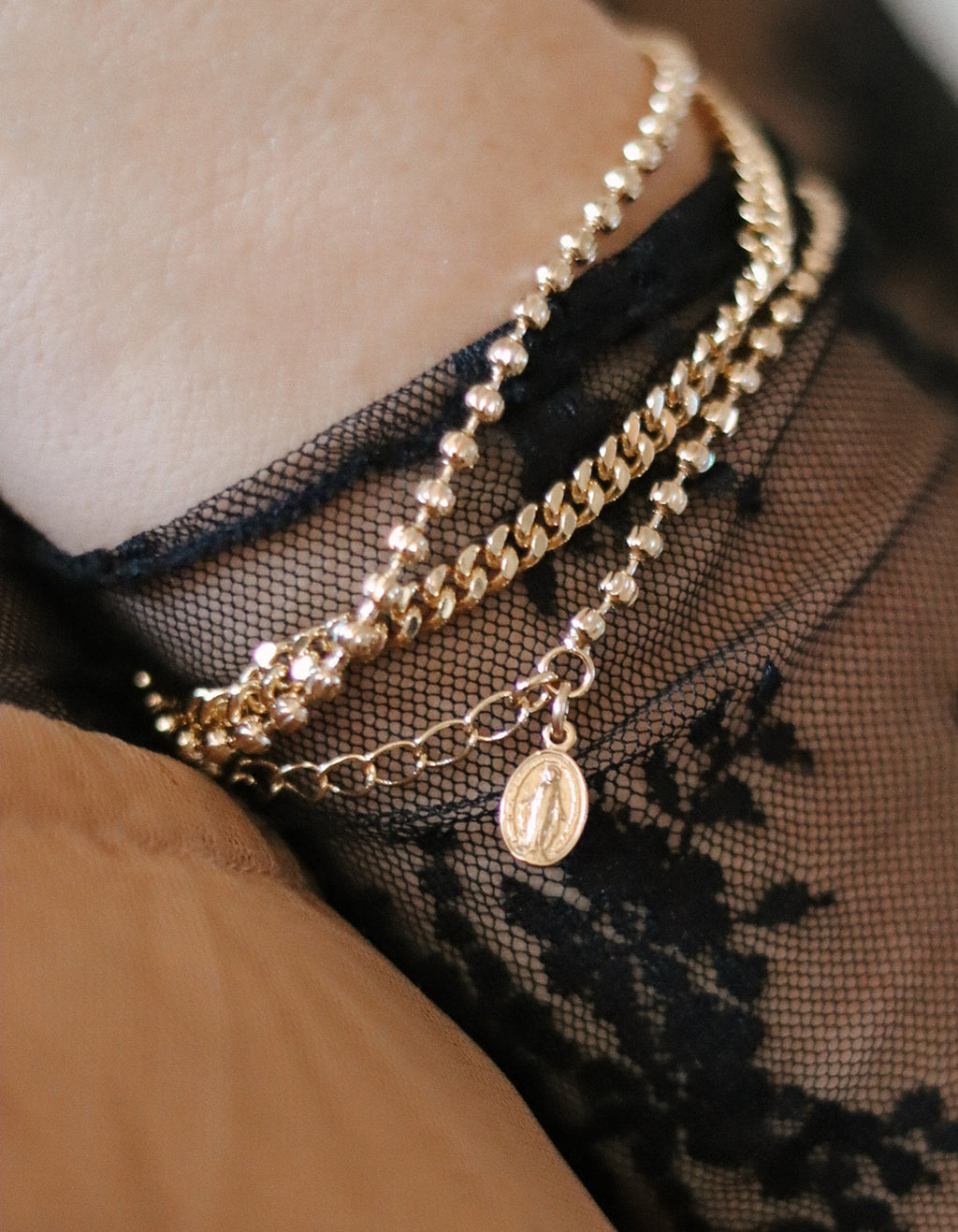 Gold-tone medal charm bracelet with pearl-bead and chain layers