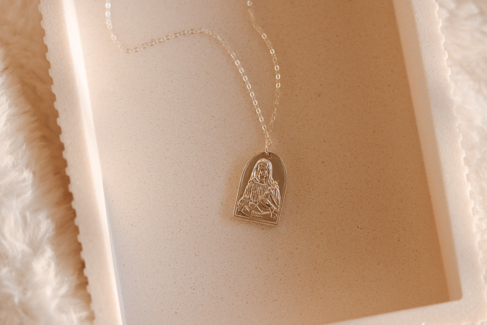 Sterling silver necklace featuring a small Saint Catherine heart pendant