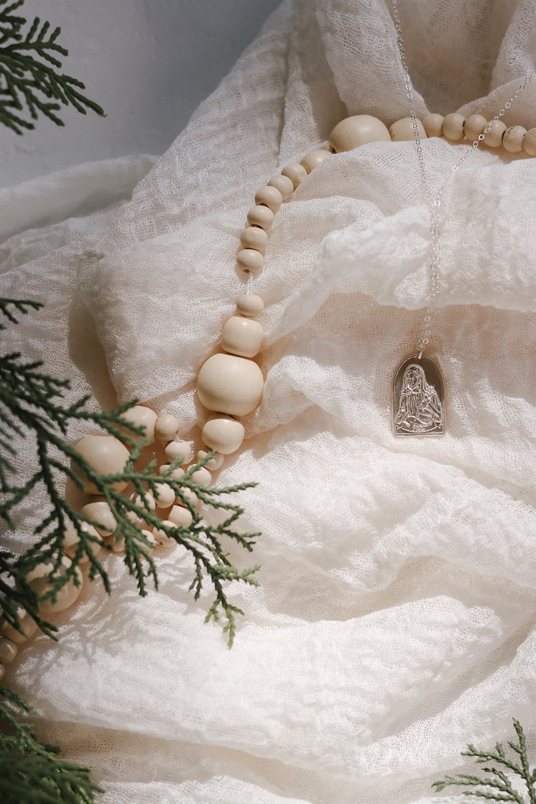 Sterling silver Saint Catherine charm on a beaded strand with small cross pendant
