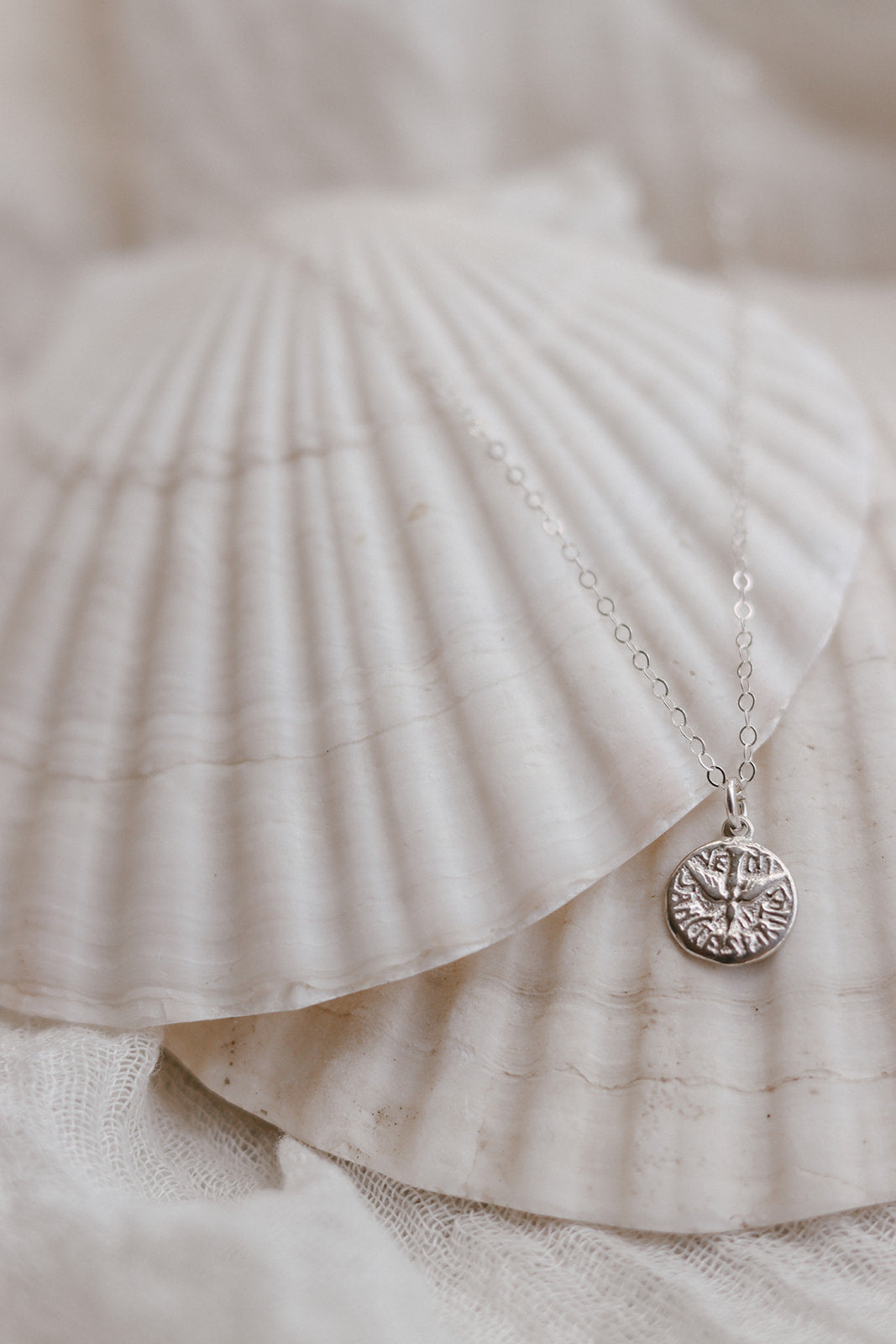 Sterling silver necklace with circular Holy Spirit pendant on short chain