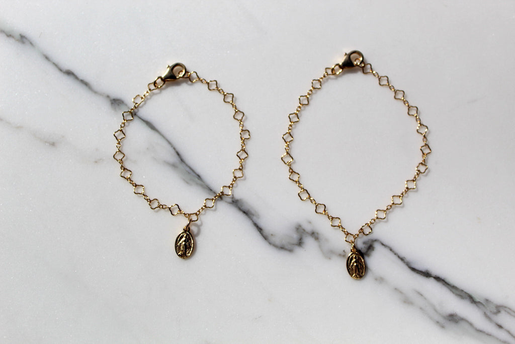 Gold chain charm bracelet set with circular medallion charms