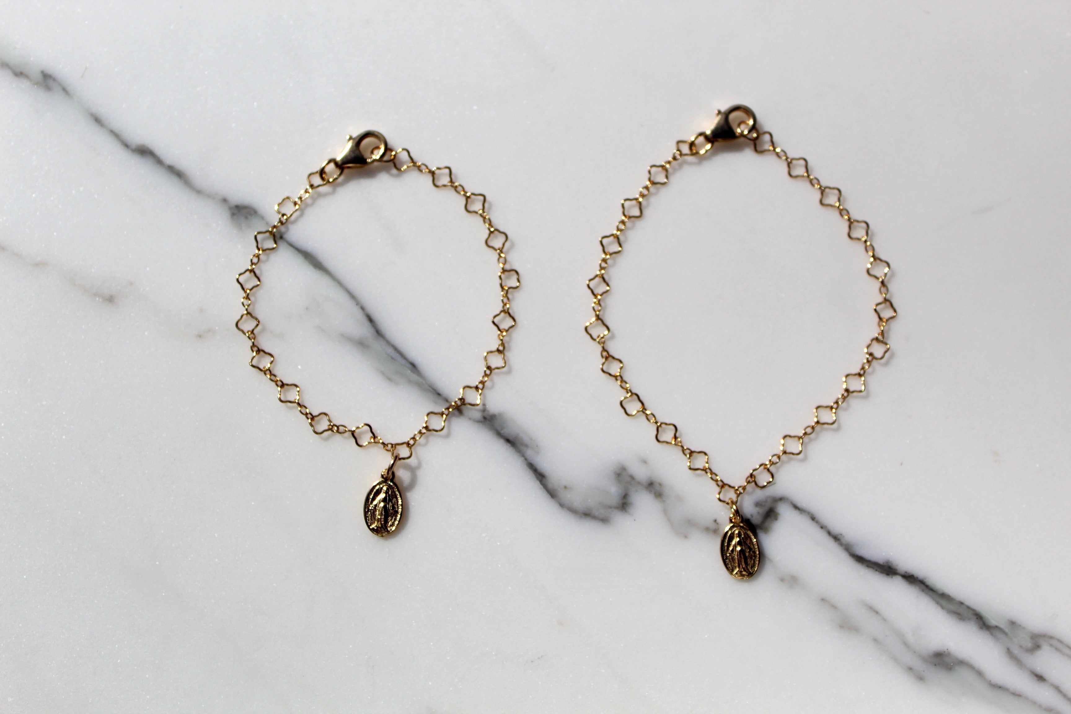 Gold chain charm bracelet set with circular medallion charms